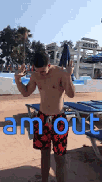 a shirtless man is standing in front of a water park with the word amout written on the ground