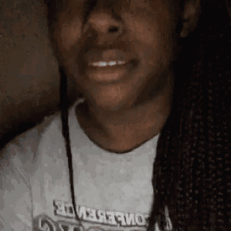 a close up of a person 's face wearing a t-shirt with the word believe on it .