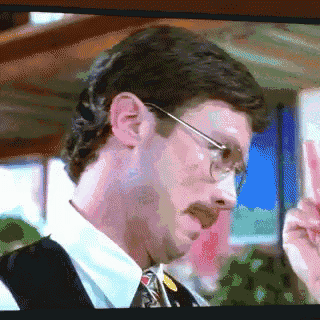 a pixelated image of a man wearing glasses and a vest