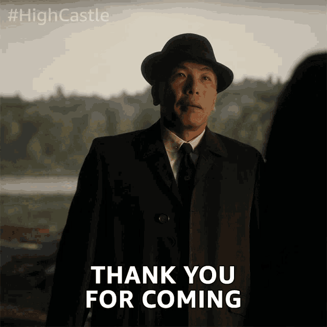 a man in a suit and hat is saying " thank you for coming "