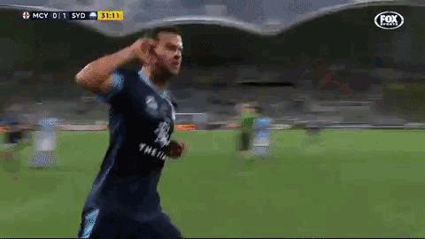a soccer player celebrates a goal with a fox logo in the background