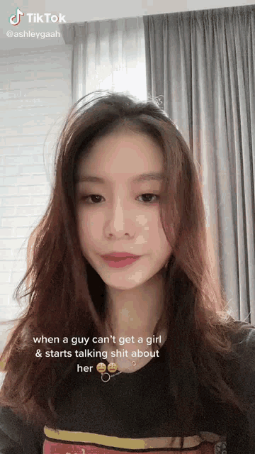 a girl with long hair is talking about a guy who can 't get a girl