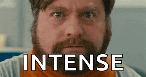 a man with a beard and blue eyes is looking at the camera with the word intense written on his face .