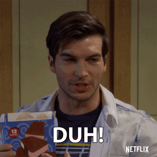 a man is holding a box of ice cream sandwiches with the word duh on it