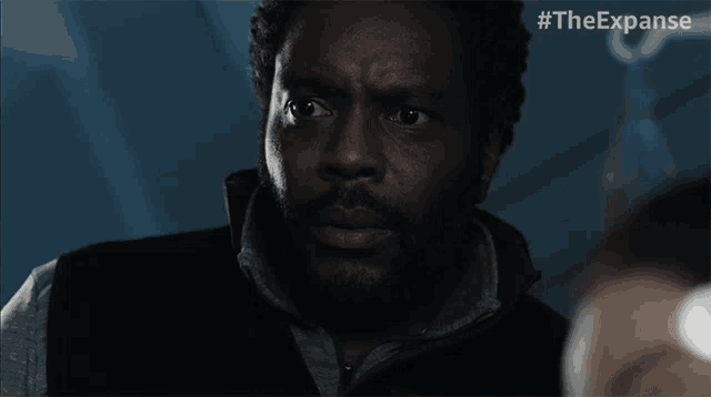 a close up of a man 's face with the hashtag #theexpanse on the bottom