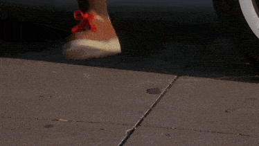 a woman in a red dress is holding a red ball