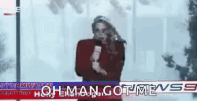 a woman stands in front of a sign that says oh man got mevss