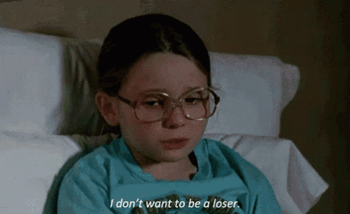 a young girl with glasses is laying in a hospital bed and says i don 't want to be a loser