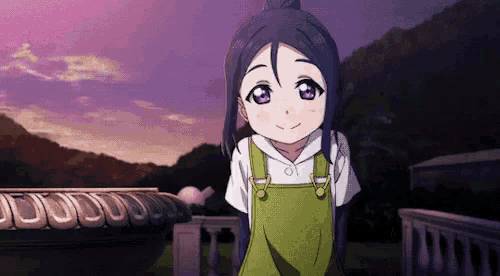 a little girl with purple eyes and overalls is standing on a balcony .