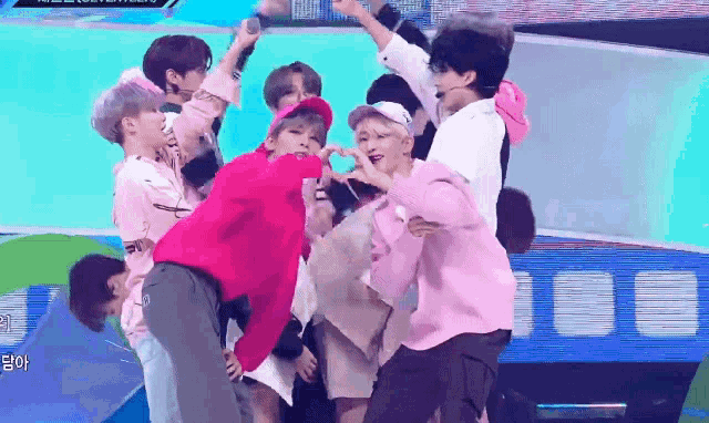 a group of young men are posing for a picture on stage .