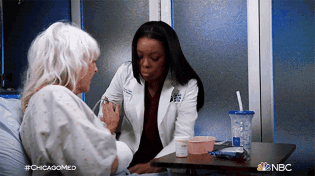 a doctor is talking to an elderly woman in a hospital bed with #chicagomed on the bottom