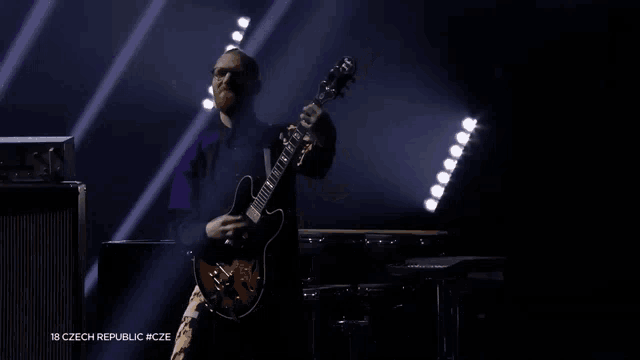 a man playing a guitar with the words 18 czech republic #cze