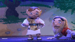 a puppet of jesus and a puppet of a man are on stage