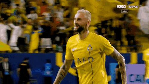 a soccer player in a yellow shirt with afd on it
