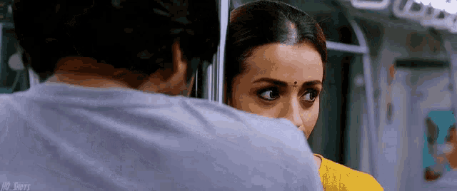 a man and a woman are looking at each other on a bus .