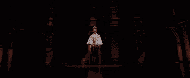 a man in a crown and robe is on a stage