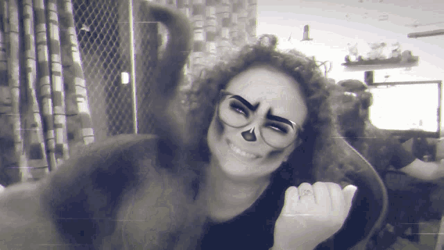 a woman with a skeleton face paint and glasses