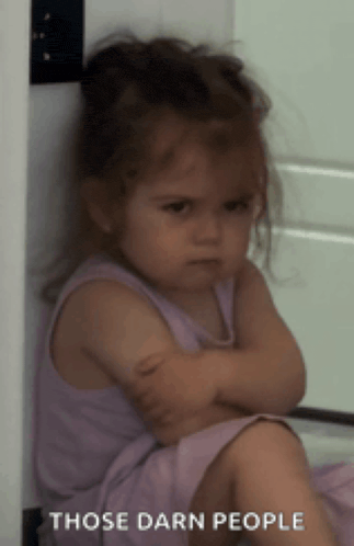 a little girl is sitting with her arms crossed and the words those darn people above her