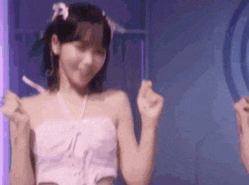 a woman in a white dress is dancing in front of a mirror in a room .