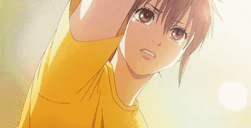 a close up of a girl in a yellow shirt with her arms outstretched .
