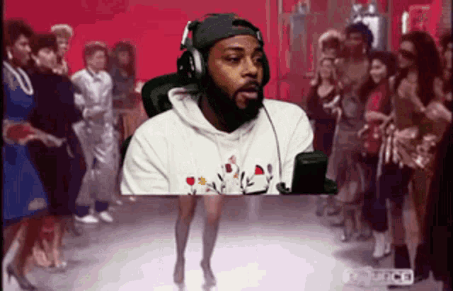 a man wearing headphones is standing in front of a group of people