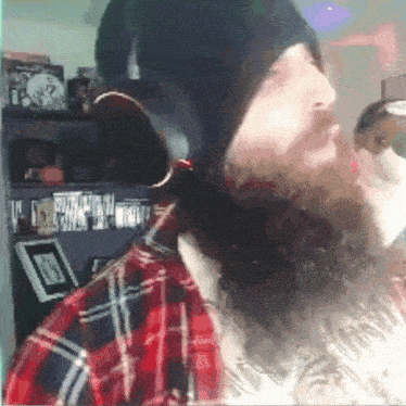 a man wearing a plaid shirt and a black beanie