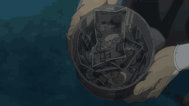 a person is holding a tin filled with money and one of the bills says 100