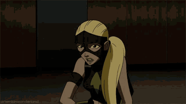 a cartoon of a girl in a green and yellow superhero costume with the caption artemis wonderland