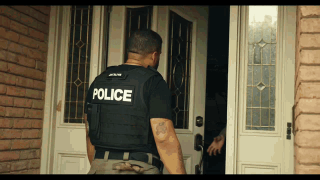 a man wearing a vest that says police on it