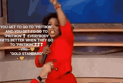a woman in a red dress is singing into a microphone and says " you get to go to " pritikin "