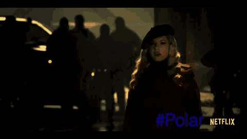 a woman in a red coat is standing in front of a group of people and the word polar is on the bottom
