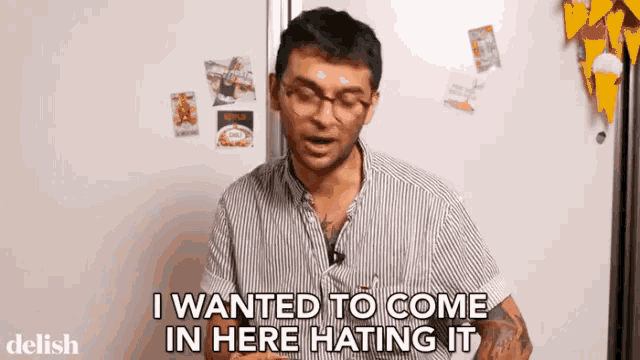 a man in a striped shirt says i wanted to come in here hating it