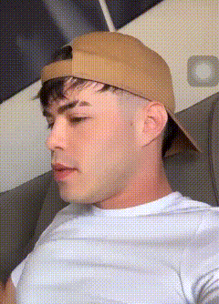 a man wearing a white shirt and a brown hat