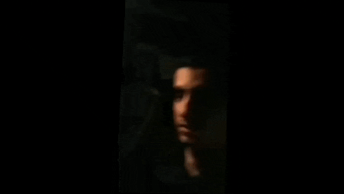 a close up of a person 's face in the dark .