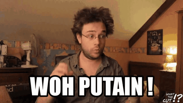 a man with glasses says " wow putain " in a room