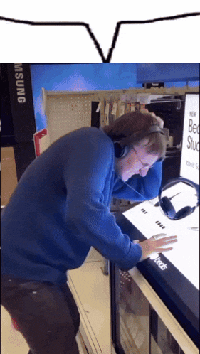 a man wearing headphones is looking at a bed stud