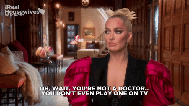 a woman in a pink dress says " oh wait you 're not a doctor you dont even play one on tv "