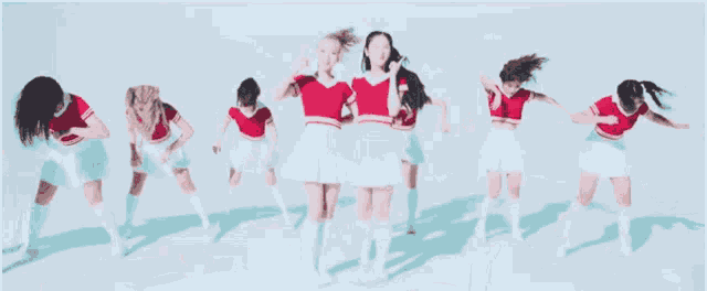 a group of young women are standing next to each other and dancing .