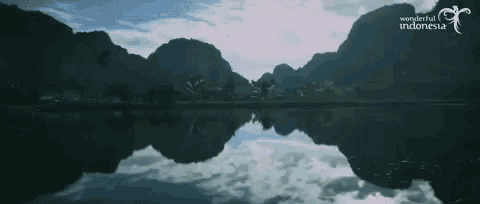 a lake with mountains in the background and the words " wonderful indonesia " on the bottom