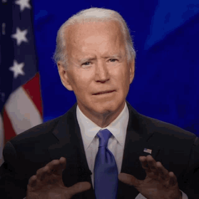 a man in a suit and tie is giving a speech