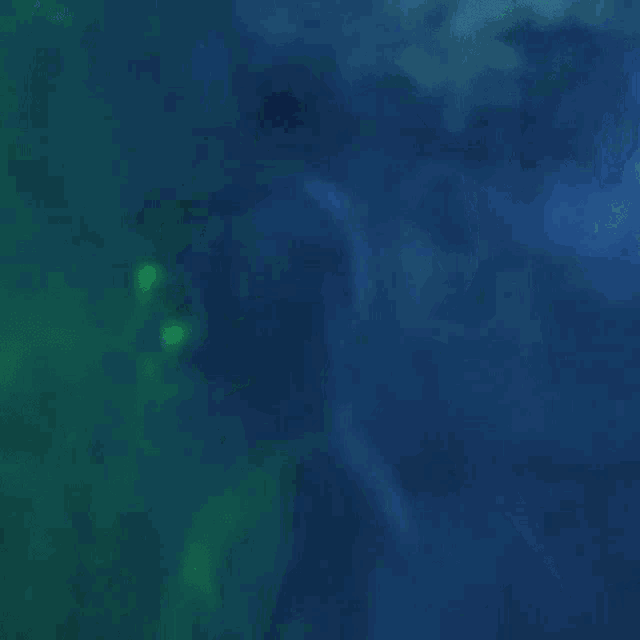 a blurred image of a person swimming in the water