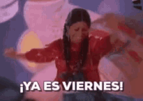 a woman in a red dress is dancing with her arms outstretched and the words `` ya es viernes '' written below her .