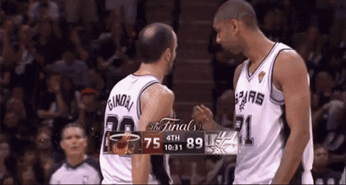 two basketball players are shaking hands in front of a scoreboard that says the finals 4th