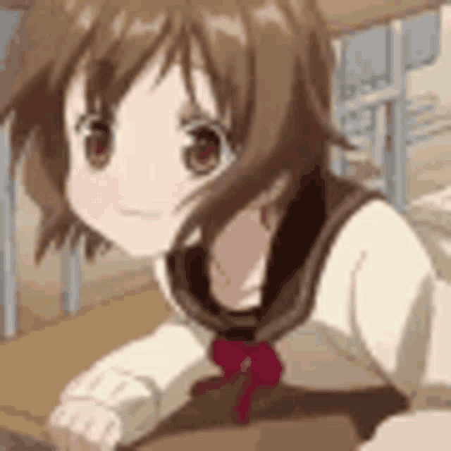 a young girl is sitting at a desk in a classroom .