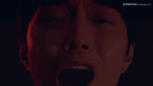 a close up of a person 's face with the words arrow presents above