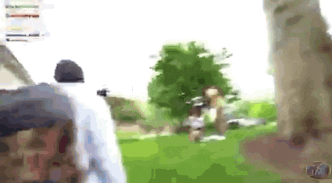 a blurry picture of a person walking in a park .