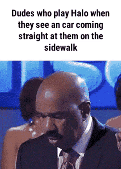 a man in a suit and tie is looking down at something