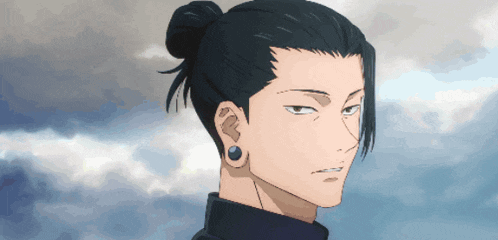a man with a bun and ear piercings looks at the sky