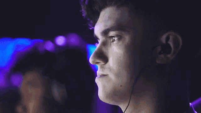 a close up of a man 's face wearing ear buds