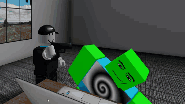 a man in a roblox hat stands next to a laptop
